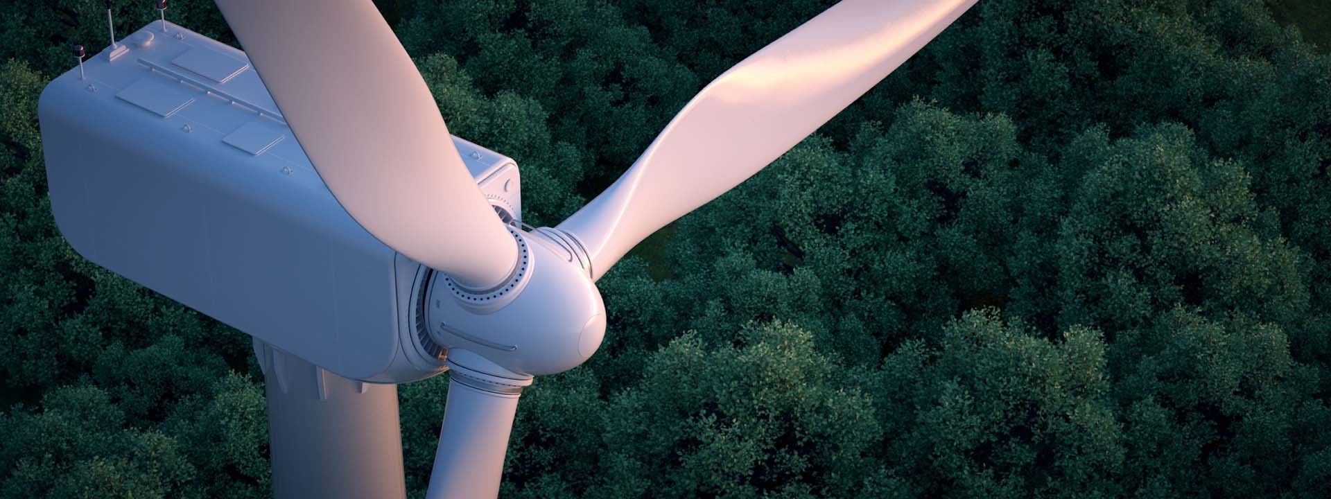 top of a wind turbine against a forest